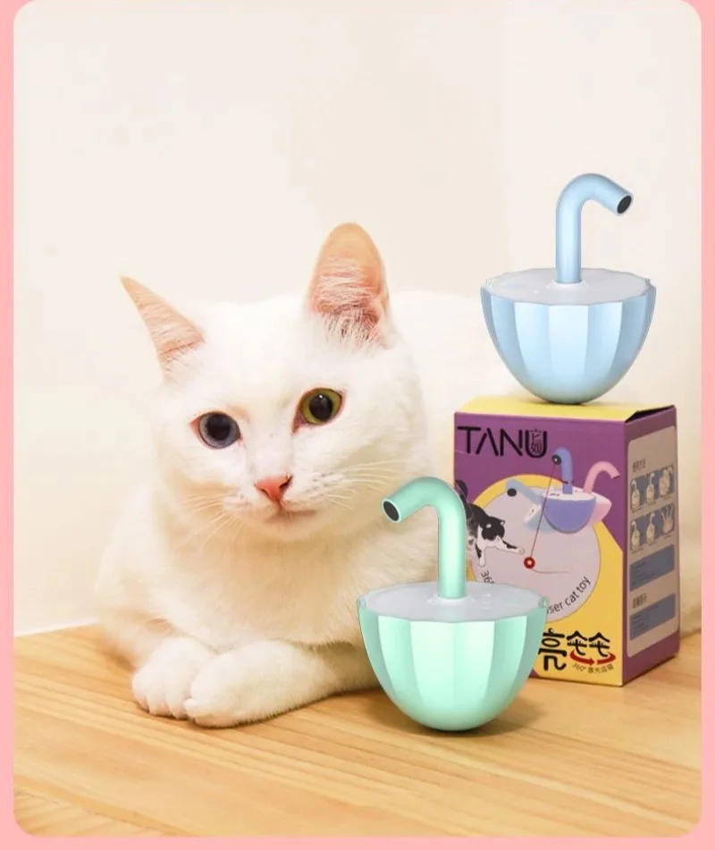 Un gato blanco sentado en una mesa junto a un tazón azul y una caja