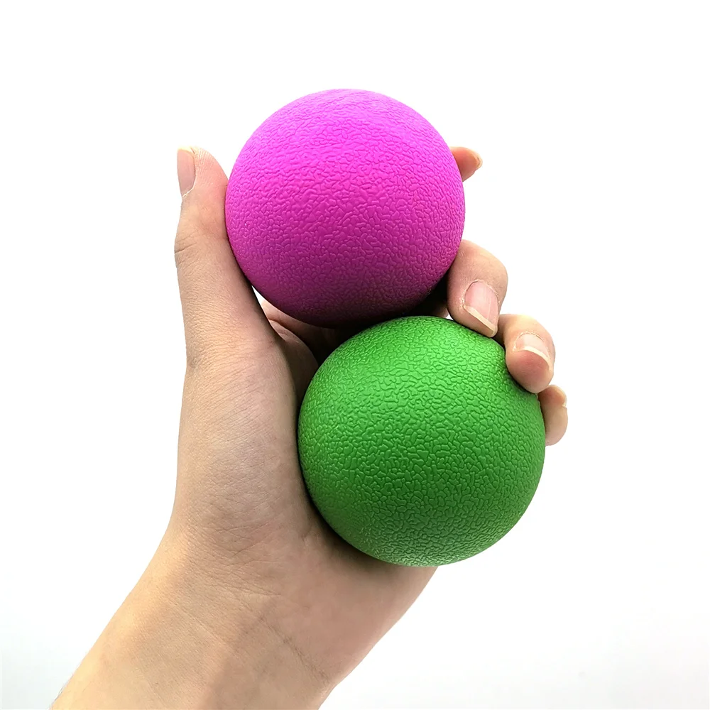 Pelota de masaje junto a una esterilla de yoga