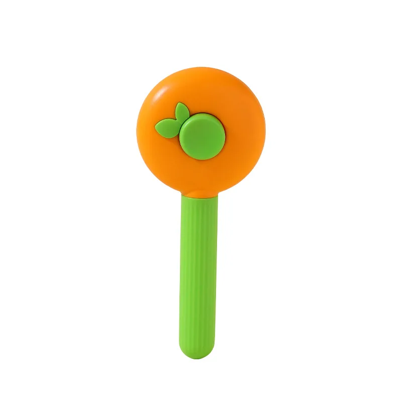 Un juguete verde y naranja con forma de piruleta