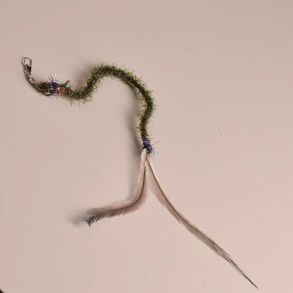 Gatito interactuando con la varita de plumas