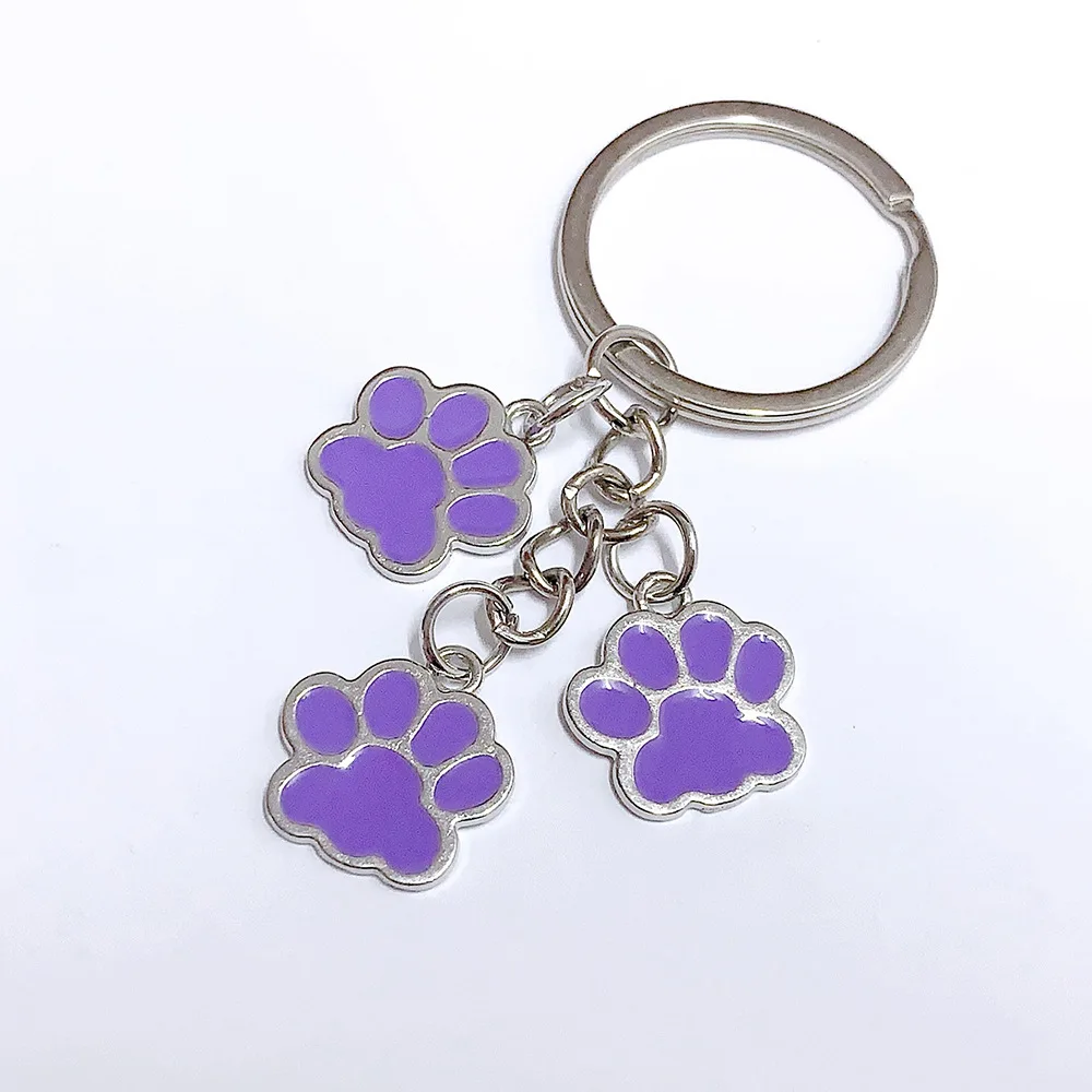 Llavero de patas de perro y gato en estilo de dibujos animados