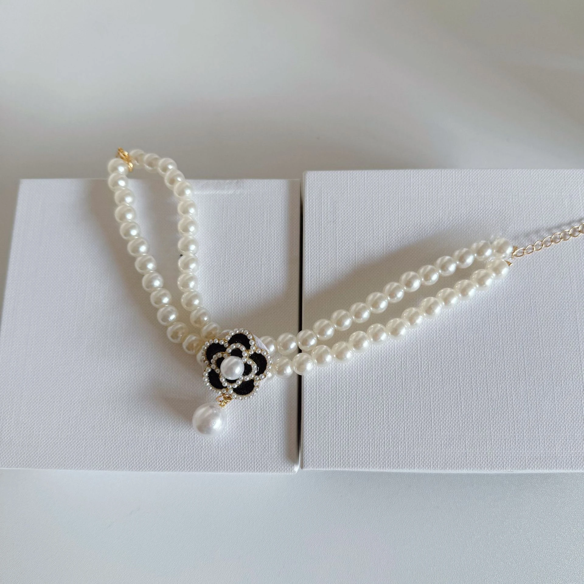 Detalle de perlas y peluche del collar