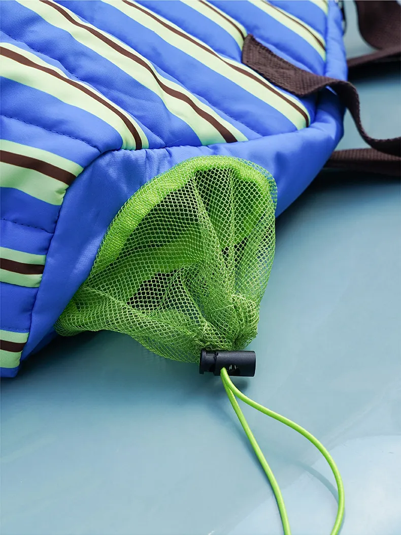 Bolsa plegada junto a un transportín rígido para mostrar diferencia de tamaño