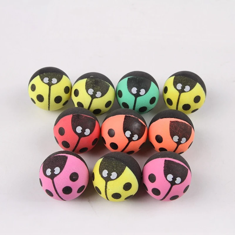 Pelota de insecto junto a otros juguetes para gatos