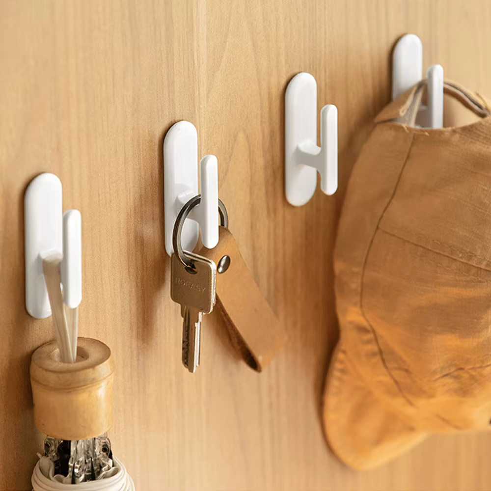 Soporte autoadhesivo sin perforaciones para cuerdas de persianas